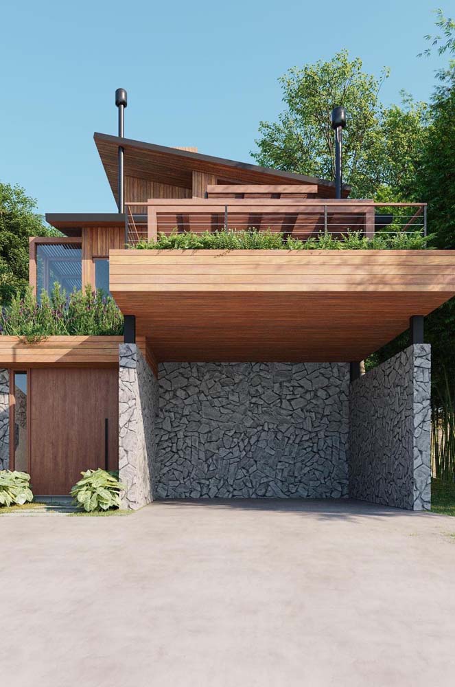 Plantele si pietrele adauga o nota rustica fatadei acestei case moderne din lemn.